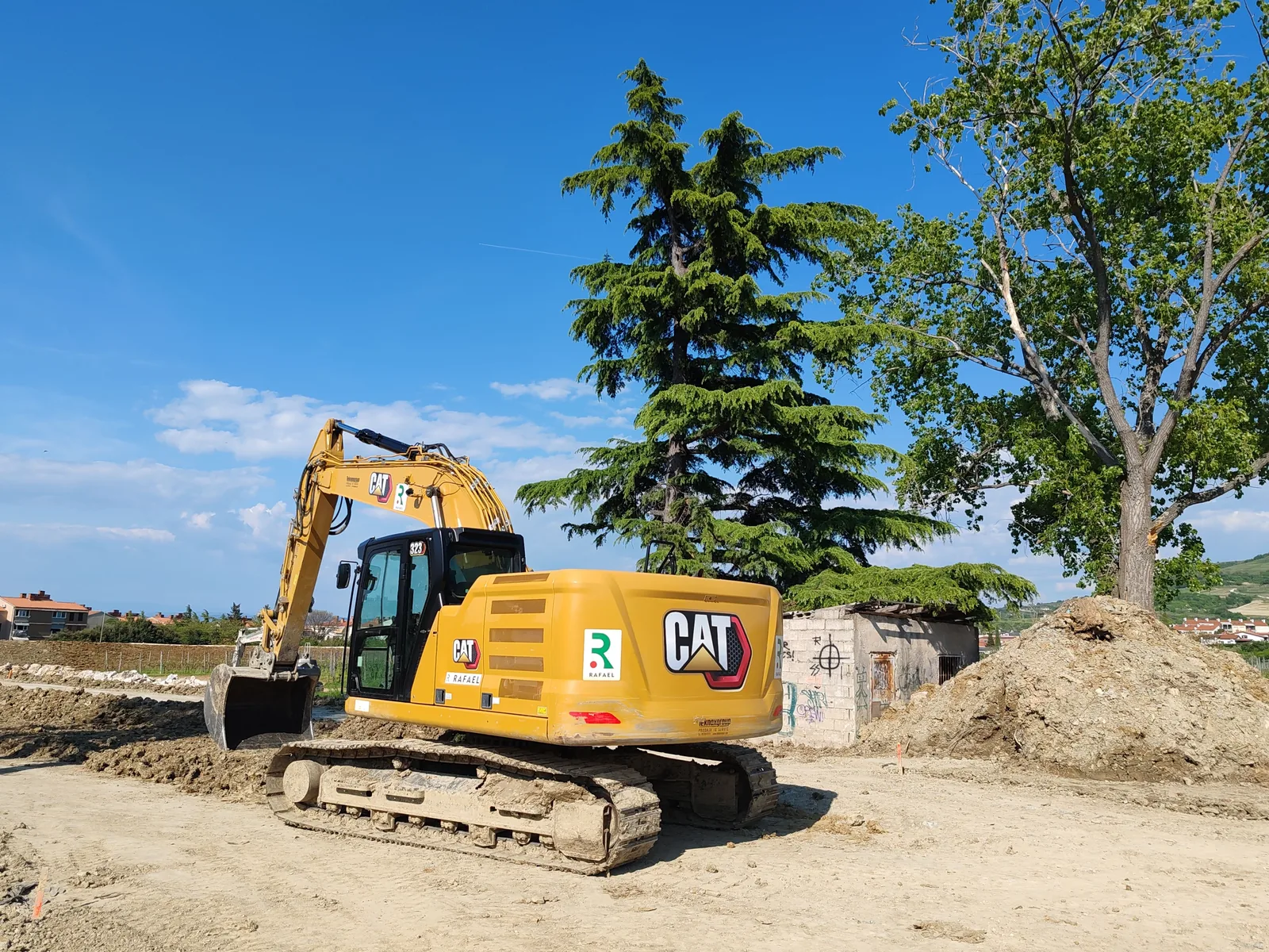 An excavator working a freshly cut site
